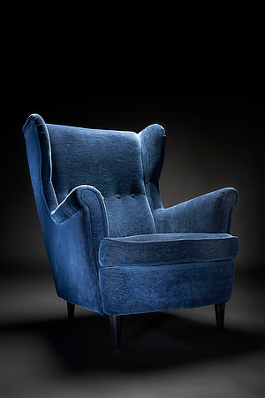 A Blue High-back chair on a dark background