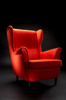 A Orange High-back chair on a dark background